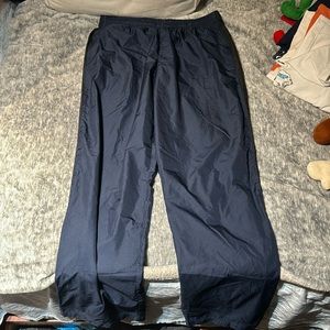 Navy with black stripes Nike size XL and is  windbreaker pants